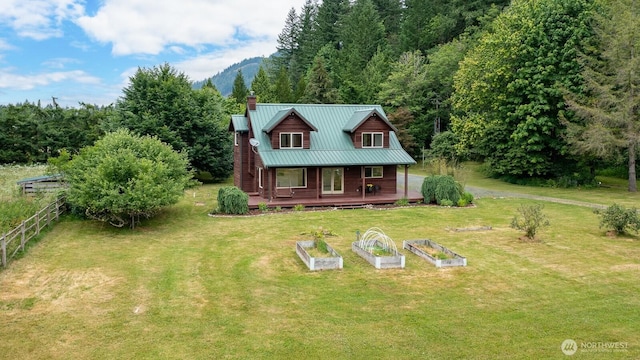 6373 Eastwood Rd, Deming, WA 98244 - view of front of house featuring a garden, a chimney, covered porch, and a metal roof