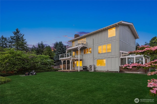 11665 NE Sunset Loop, Bainbridge Island, WA 98110 - rear view of house featuring a balcony, board and batten siding, a lawn, and a chimney