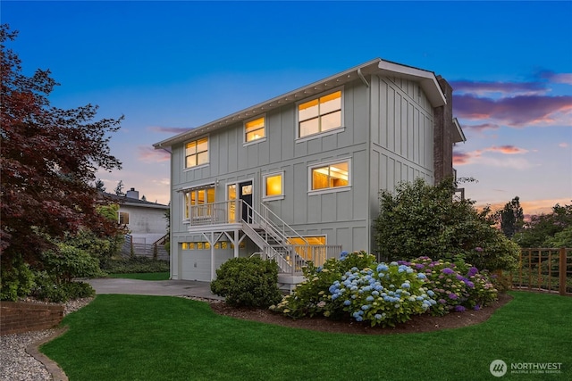 11665 NE Sunset Loop, Bainbridge Island, WA 98110 - rear view of house with board and batten siding, stairs, driveway, and a garage