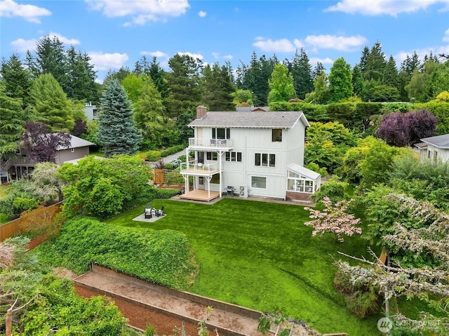 11665 NE Sunset Loop, Bainbridge Island, WA 98110 - back of property with a balcony, a lawn, a patio area, and a chimney