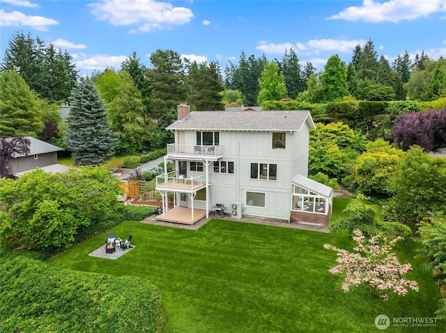 11665 NE Sunset Loop, Bainbridge Island, WA 98110 - back of property featuring a balcony, a chimney, a yard, and roof with shingles