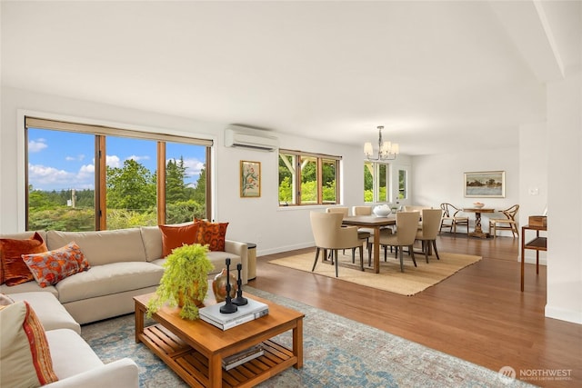 11665 NE Sunset Loop, Bainbridge Island, WA 98110 - living room featuring a wall mounted AC, a chandelier, and wood finished floors