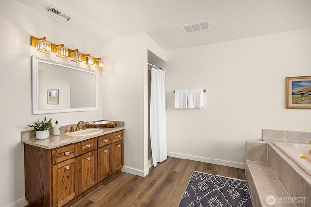 11665 NE Sunset Loop, Bainbridge Island, WA 98110 - bathroom with vanity, wood finished floors, a garden tub, and a shower with shower curtain