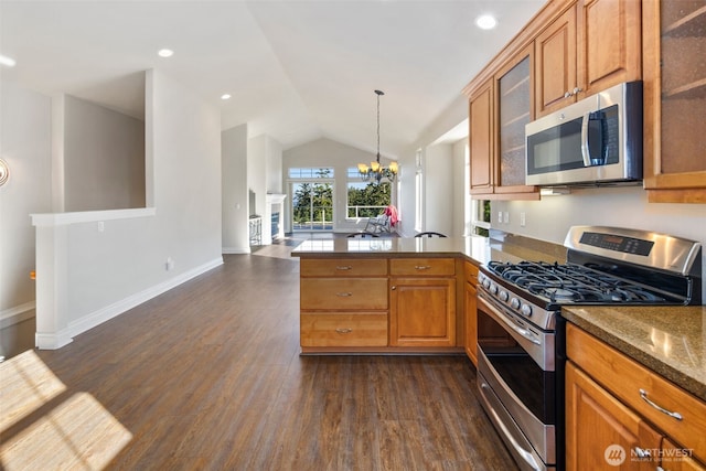 3224 Overlook Loop, Ilwaco, WA 98624 - kitchen with appliances with stainless steel finishes, a peninsula, dark wood-style floors, brown cabinets, and vaulted ceiling