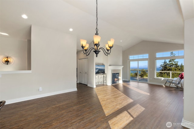 3224 Overlook Loop, Ilwaco, WA 98624 - unfurnished living room with high vaulted ceiling, dark wood-style flooring, a chandelier, recessed lighting, and a tiled fireplace