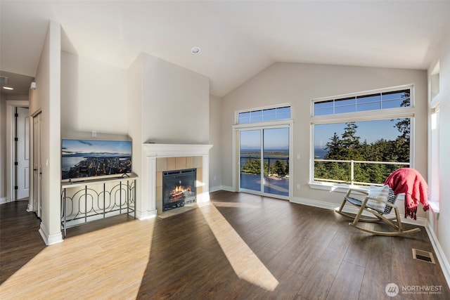 3224 Overlook Loop, Ilwaco, WA 98624 - unfurnished living room featuring a fireplace, wood finished floors, and high vaulted ceiling