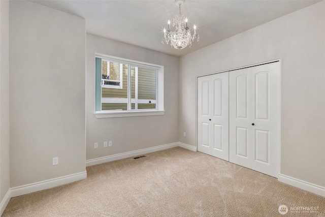 3224 Overlook Loop, Ilwaco, WA 98624 - unfurnished bedroom featuring a chandelier, carpet floors, and a closet