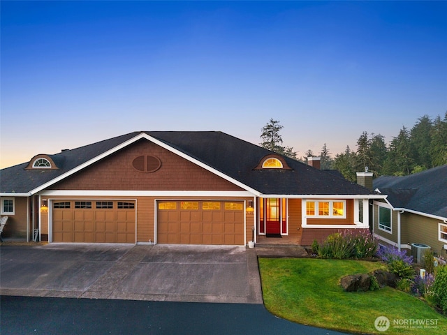 3224 Overlook Loop, Ilwaco, WA 98624 - view of front facade featuring an attached garage, driveway, a front yard, and a chimney