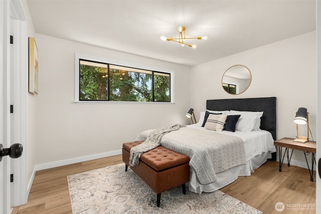 21239 15th Ave S, Des Moines, WA 98198 - bedroom with a chandelier and light wood-style floors