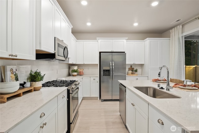 14121 195th Street Ct E, Graham, WA 98338 - kitchen featuring stainless steel appliances, white cabinets, recessed lighting, and decorative backsplash