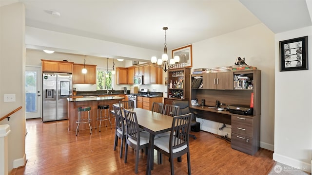 4650 NE 3rd Ln Unit F1, Renton, WA 98059 - dining space with a chandelier and light wood-type flooring