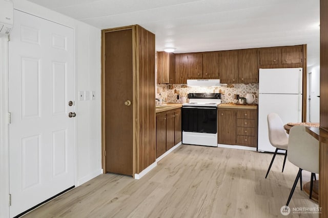 6219 Shamrock Rd, Maple Falls, WA 98266 - kitchen featuring white appliances, extractor fan, light wood-style floors, backsplash, and light countertops