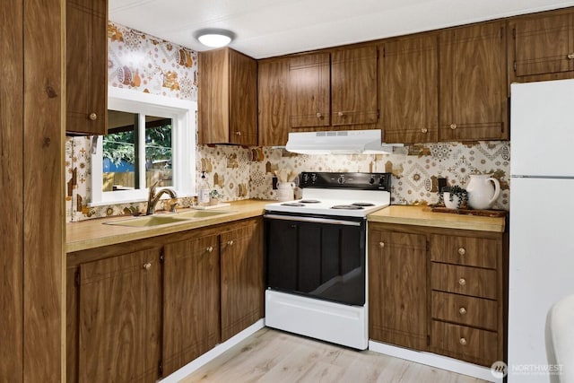 6219 Shamrock Rd, Maple Falls, WA 98266 - kitchen with white appliances, under cabinet range hood, wallpapered walls, light countertops, and light wood-type flooring