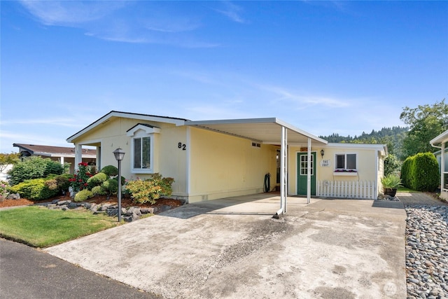 836 Harman Way S Unit 82, Orting, WA 98360 - manufactured / mobile home with a carport and concrete driveway