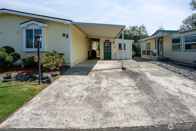 836 Harman Way S Unit 82, Orting, WA 98360 - manufactured / mobile home with driveway and an attached carport