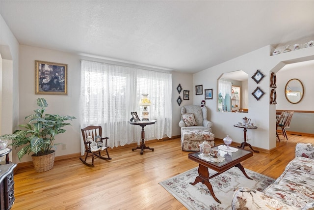 836 Harman Way S Unit 82, Orting, WA 98360 - living area with wood finished floors and arched walkways