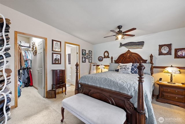 836 Harman Way S Unit 82, Orting, WA 98360 - bedroom with light carpet, a walk in closet, a closet, a ceiling fan, and ensuite bathroom