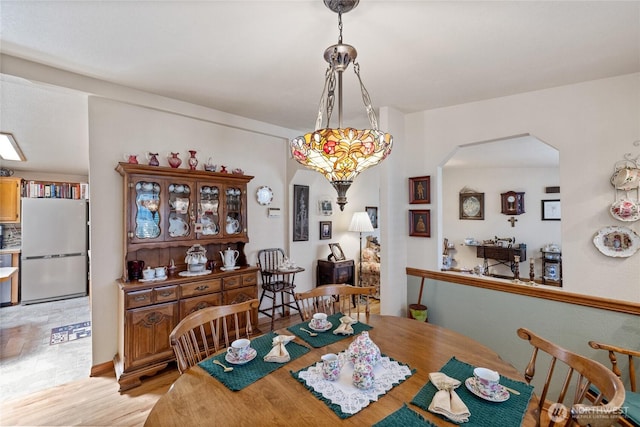 836 Harman Way S Unit 82, Orting, WA 98360 - dining room with arched walkways and light wood-style flooring
