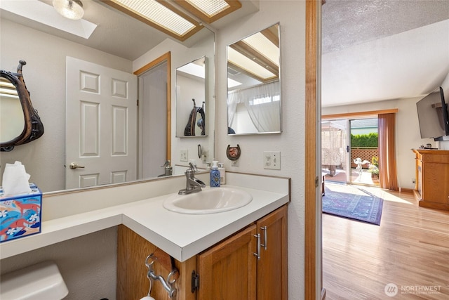 836 Harman Way S Unit 82, Orting, WA 98360 - bathroom with wood finished floors, vanity, and a skylight