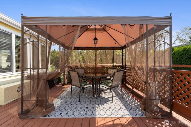 836 Harman Way S Unit 82, Orting, WA 98360 - wooden deck with a gazebo and outdoor dining space