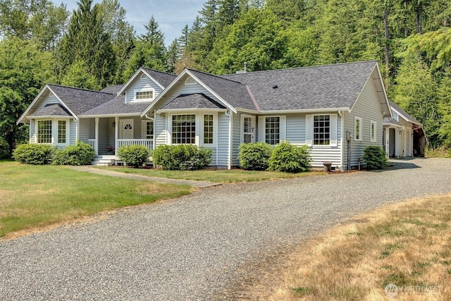 2829 Lake Langlois Rd NE, Carnation, WA 98014 - view of front of property featuring covered porch, driveway, a shingled roof, and a front yard