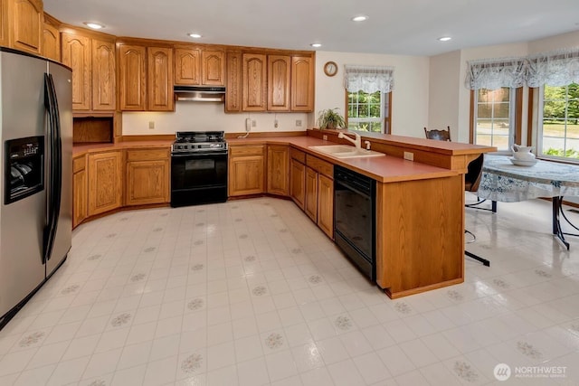 2829 Lake Langlois Rd NE, Carnation, WA 98014 - kitchen featuring gas stove, stainless steel fridge with ice dispenser, black dishwasher, under cabinet range hood, and plenty of natural light