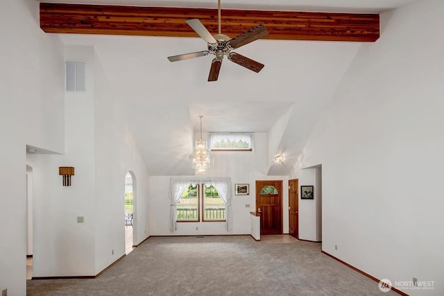 2829 Lake Langlois Rd NE, Carnation, WA 98014 - unfurnished living room with high vaulted ceiling, carpet floors, arched walkways, beamed ceiling, and a ceiling fan