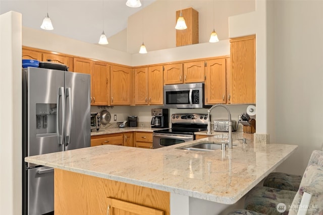 16116 4th Ave NW, Arlington, WA 98223 - kitchen featuring appliances with stainless steel finishes, a peninsula, light stone countertops, vaulted ceiling, and a breakfast bar area