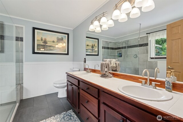 16116 4th Ave NW, Arlington, WA 98223 - full bathroom with double vanity, tile patterned floors, crown molding, a stall shower, and a wainscoted wall