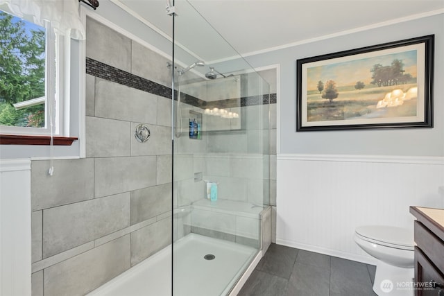 16116 4th Ave NW, Arlington, WA 98223 - bathroom with a tile shower, vanity, ornamental molding, tile patterned flooring, and a wainscoted wall