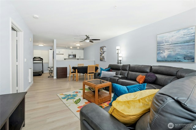 17426 Bothell Way NE Unit A105, Bothell, WA 98011 - living room with light wood-style floors and a ceiling fan