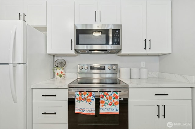 17426 Bothell Way NE Unit A105, Bothell, WA 98011 - kitchen featuring stainless steel appliances, white cabinetry, and light stone counters