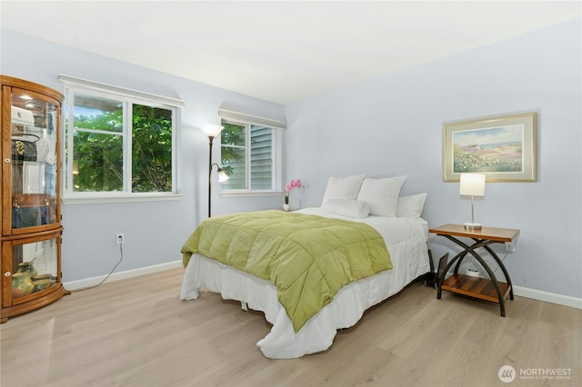 17426 Bothell Way NE Unit A105, Bothell, WA 98011 - bedroom featuring light wood-type flooring and baseboards