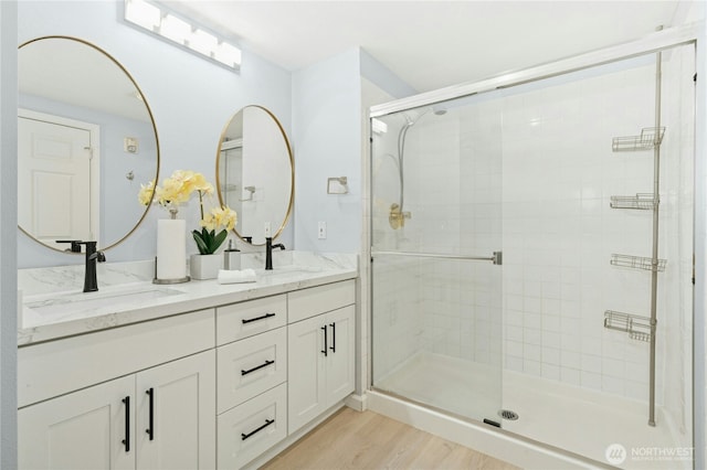 17426 Bothell Way NE Unit A105, Bothell, WA 98011 - bathroom featuring a shower stall, wood finished floors, and double vanity