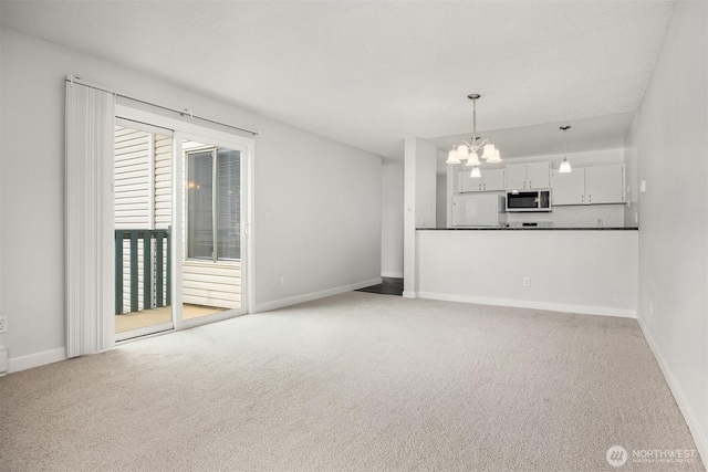 17431 Ambaum Blvd S Unit C24, Burien, WA 98148 - unfurnished living room with light carpet and a chandelier