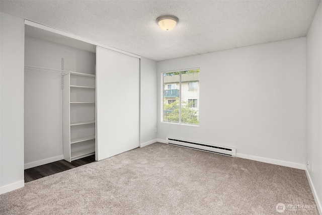 17431 Ambaum Blvd S Unit C24, Burien, WA 98148 - unfurnished bedroom with a baseboard heating unit, carpet floors, a textured ceiling, and a closet