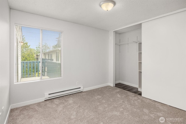 17431 Ambaum Blvd S Unit C24, Burien, WA 98148 - unfurnished bedroom featuring a baseboard heating unit, carpet, a textured ceiling, and a closet