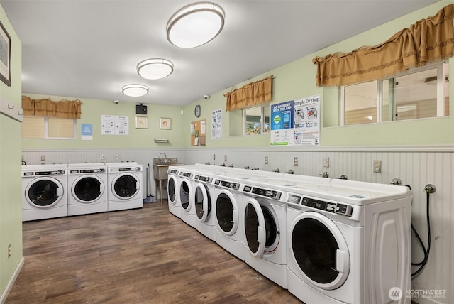 17431 Ambaum Blvd S Unit C24, Burien, WA 98148 - community laundry featuring washer and clothes dryer, a wainscoted wall, and wood finished floors
