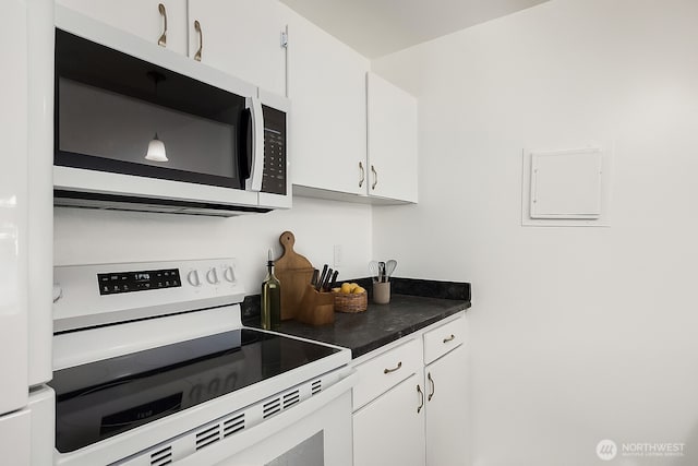 17431 Ambaum Blvd S Unit C24, Burien, WA 98148 - kitchen featuring white appliances, white cabinets, dark countertops, and electric panel