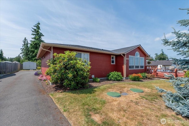 1890 Edgewood Dr, Camano Island, WA 98282 - view of front of property featuring a wooden deck, driveway, and a storage shed