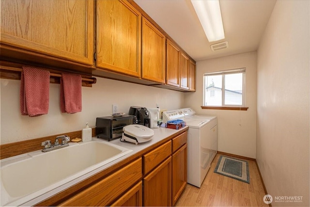 1890 Edgewood Dr, Camano Island, WA 98282 - laundry area featuring light wood-style flooring, cabinet space, and independent washer and dryer