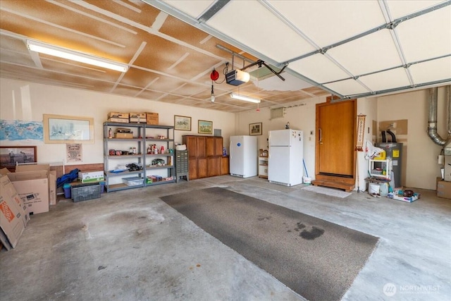 1890 Edgewood Dr, Camano Island, WA 98282 - garage with freestanding refrigerator, electric water heater, and a garage door opener