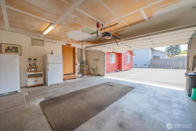 1890 Edgewood Dr, Camano Island, WA 98282 - garage with freestanding refrigerator and a garage door opener