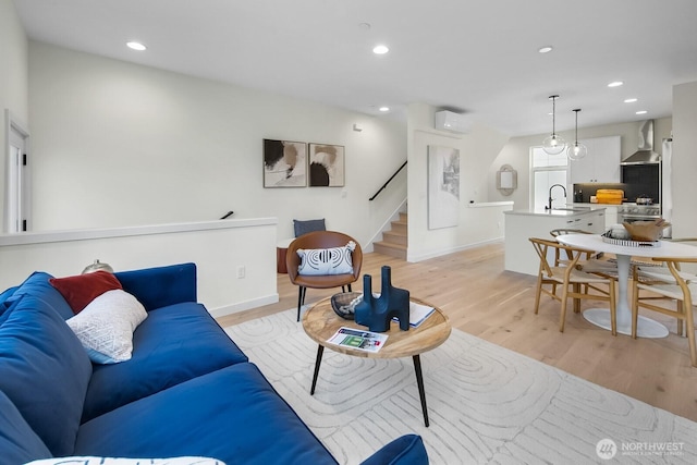 501 11th Ave E, Seattle, WA 98102 - living area featuring light wood-style flooring, a wall unit AC, recessed lighting, and stairway