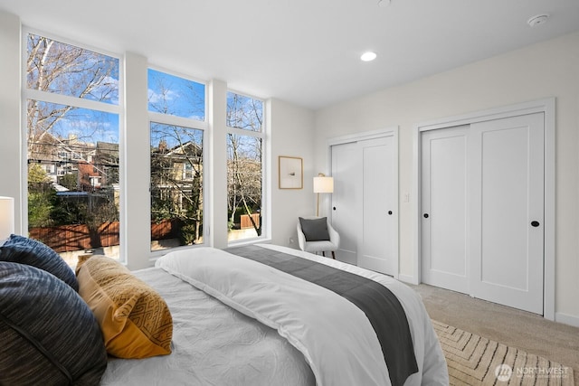 501 11th Ave E, Seattle, WA 98102 - bedroom with multiple closets, light colored carpet, and recessed lighting