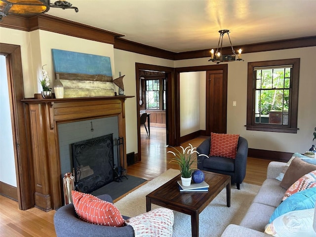 1809 NE 63rd St, Seattle, WA 98115 - living area featuring a fireplace with flush hearth, light wood-style flooring, a chandelier, and ornamental molding