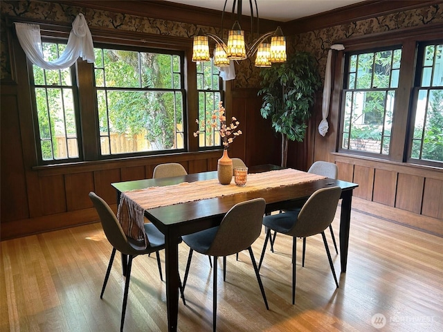 1809 NE 63rd St, Seattle, WA 98115 - dining room with a chandelier, light wood-type flooring, and wood walls