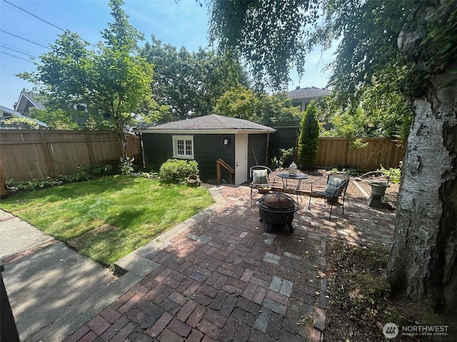 1809 NE 63rd St, Seattle, WA 98115 - fenced backyard with an outdoor structure, a fire pit, and a patio