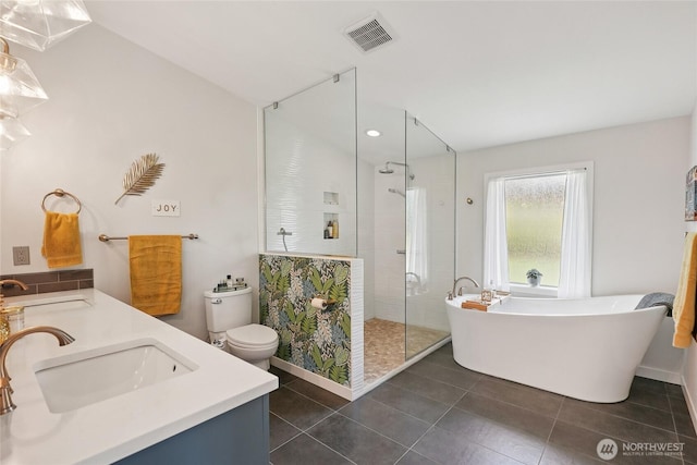 30005 NE 12th Ct, Ridgefield, WA 98642 - full bathroom featuring tile patterned floors, a stall shower, a freestanding bath, double vanity, and recessed lighting