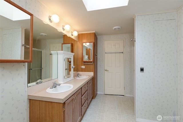2610 E Section St Unit 85, Mount Vernon, WA 98274 - full bathroom with double vanity, ornamental molding, a shower stall, a skylight, and wallpapered walls
